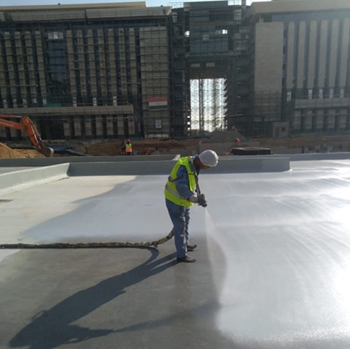 Polyurea waterproofing application on a water feature podium in the Ministries District, Egypt.