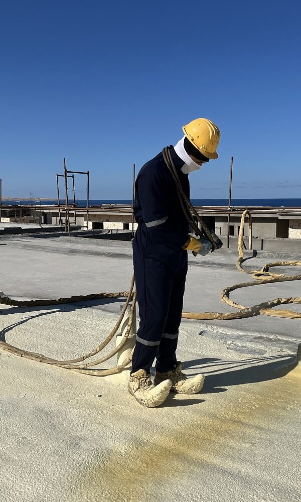 "Certified Technician Spraying Hot Applied Polyurethane Foam Insulation on an Egyptian Roof - Target for Industrial Services"