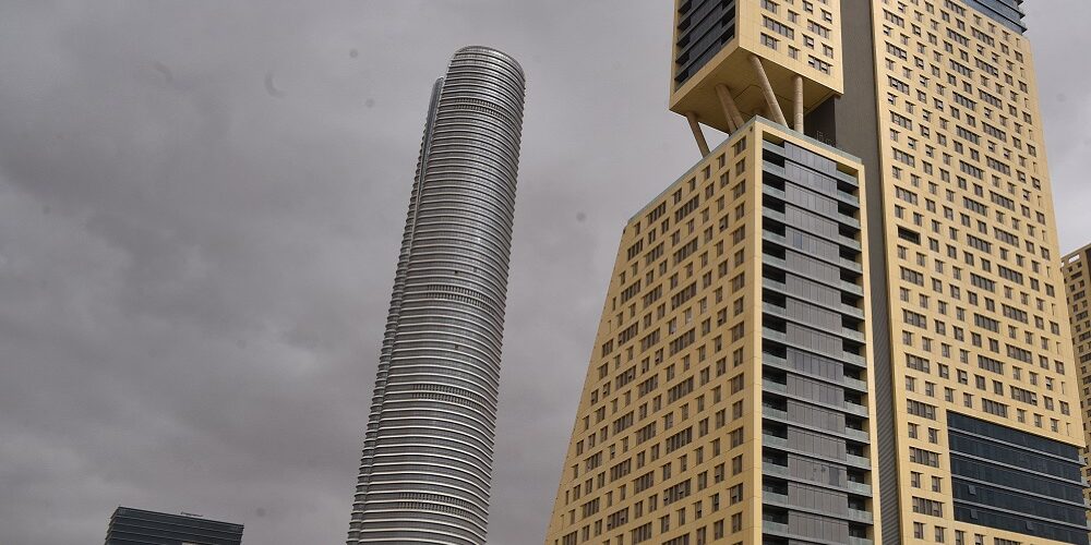 new-administrative-capital-modern-buildings-mena-infrastructure Modern high-rise buildings in Egypt's New Administrative Capital under a cloudy sky, symbolizing new infrastructure and construction challenges.