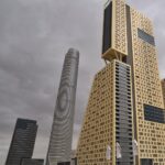 Modern high-rise buildings in Egypt's New Administrative Capital under a cloudy sky, symbolizing new infrastructure and construction challenges.