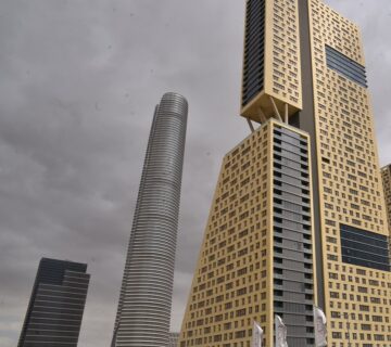 Modern high-rise buildings in Egypt's New Administrative Capital under a cloudy sky, symbolizing new infrastructure and construction challenges.