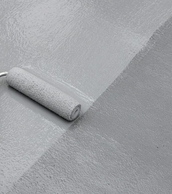 Applying an aliphatic topcoat by roller over a waterproofing membrane
