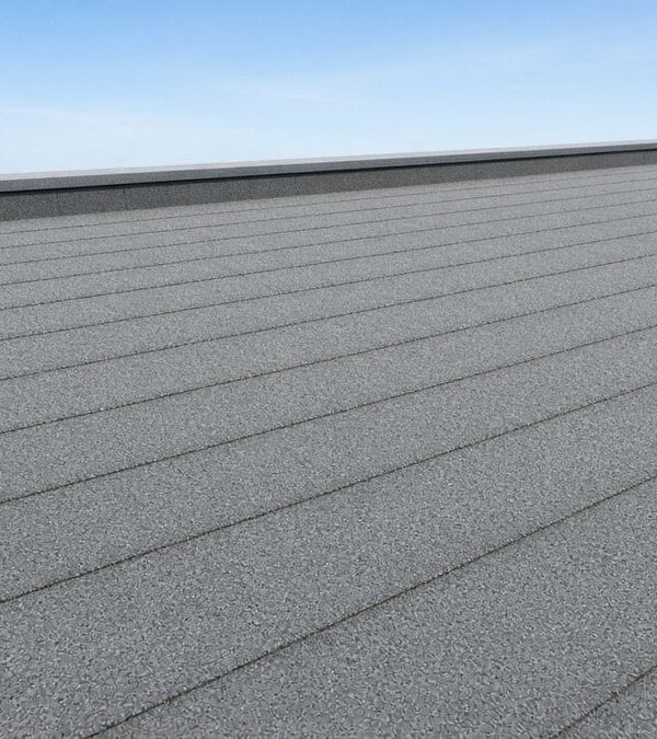 Grey mineral-slated exposed roof membrane installed on a flat roof