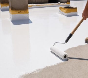 Heat insulating roof coating: white reflective coat rolled onto a concrete roof