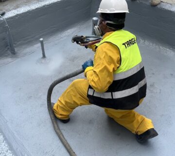 Target technician spraying polyurea inside a concrete fountain basin